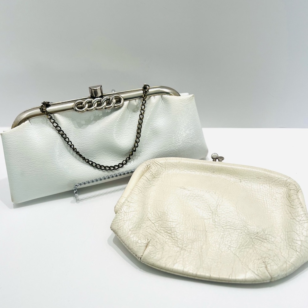 Vintage pair of white leather clutches, one is 70’s with great blk/white lining
